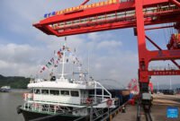 A cargo vessel prepares to depart for Yangpu Port in south China's Hainan Province along the Pinglu Canal at an operation area in Nanning Port, south China's Guangxi Zhuang Autonomous Region, Sept. 16, 2026. China opened a major new canal on Wednesday, giving its landlocked southwest a shortcut to the coast and overseas markets, particularly those in the Association of Southeast Asian Nations (ASEAN), the country's largest trading partner. Built at a cost of 72.7 billion yuan (about 10.75 billion U.S. dollars), the 134.2-kilometer Pinglu Canal runs from Nanning, capital of south China's Guangxi Zhuang Autonomous Region, to the Beibu Gulf, the closest maritime outlet for much of southwest China. (Xinhua/Cao Yiming)