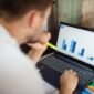 Seorang pebisnis sedang menganalisis data keuangan yang ditampilkan pada grafik pertumbuhan, menunjukkan pentingnya evaluasi cermat terhadap rencana penambahan modal sebuah perusahaan untuk memahami potensi dampaknya di masa depan.